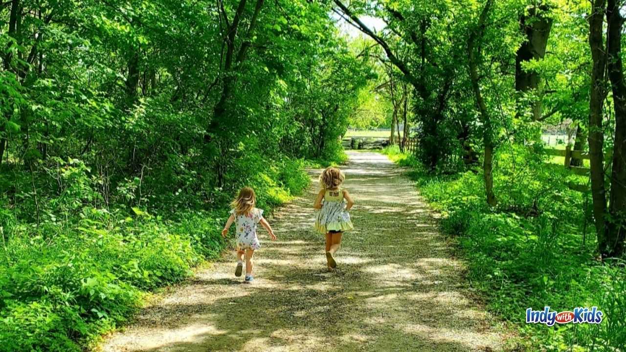 Conner Prairie Homeschool Programs: Two children sprint down a nature trail at Conner Prairie.