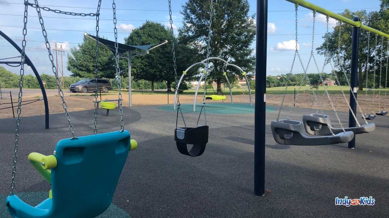 The swing set at Independence Park Greenwood includes an accessible swing, an infant swing, swing-along swings, and traditional swings.
