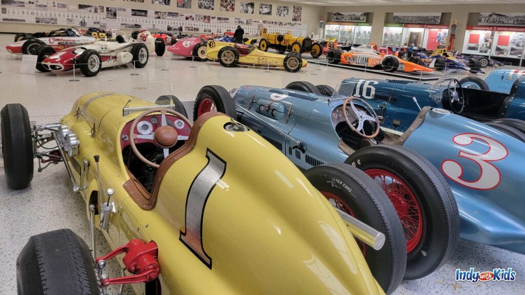 A gallery of historic Indianapolis 500 race cars at the Indianapolis Motor Speedway Museum.