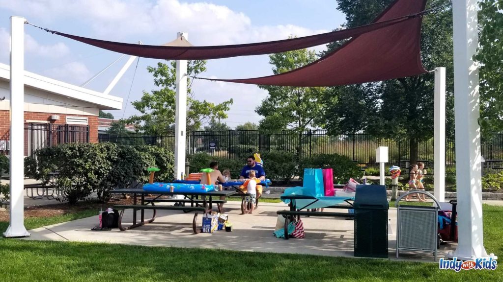 A set of picnic tables at the Carmel water Park are on a concrete slab. these picnic tables can be rented for Birthday parties at the Monon Community Center