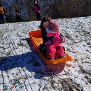 two girls on a sledding hill in indianapolis