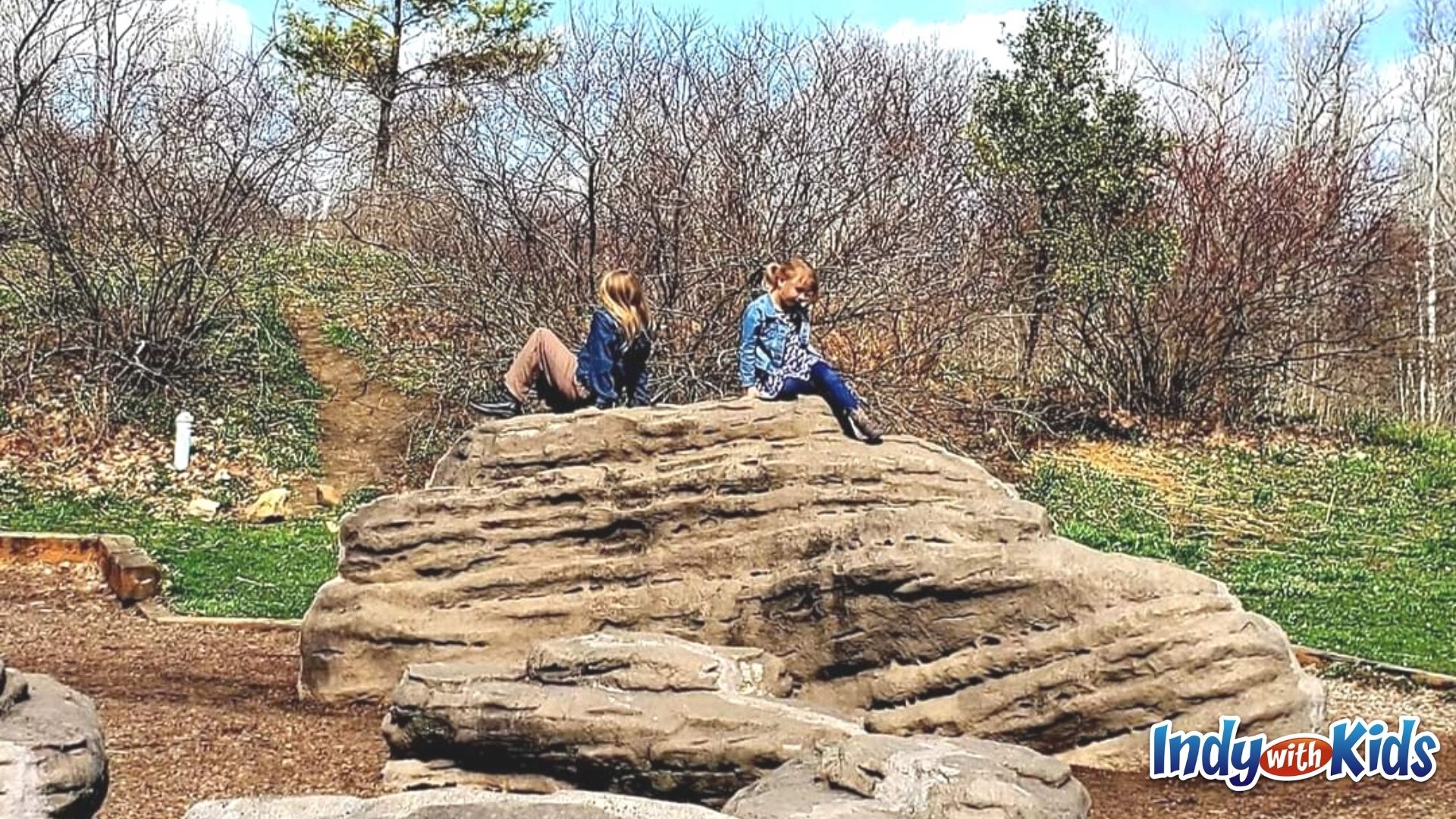 Children climb on rocks at a playground in Fort Harrison State Park.