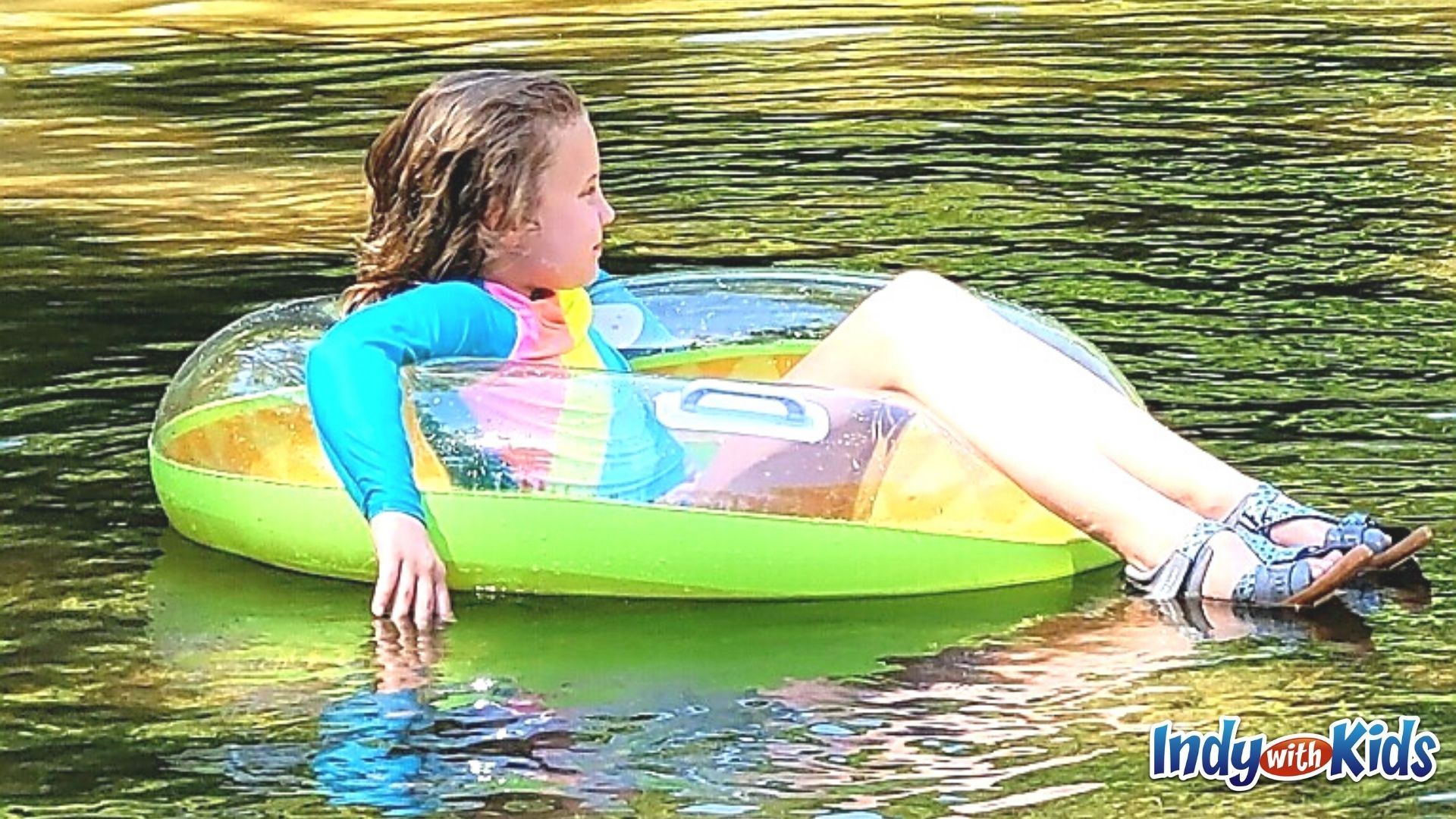 A girl floats in an inflatable tube on the river at Fort Harrison State Park.