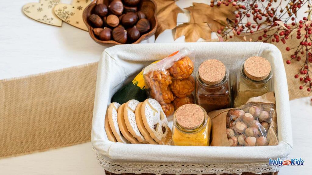 You've Been Gobbled | A Creative Thanksgiving Tradition of Giving for Kids: a goodie baskets full of cookies, spices, rice balls, and nuts sits on a table with a fall theme