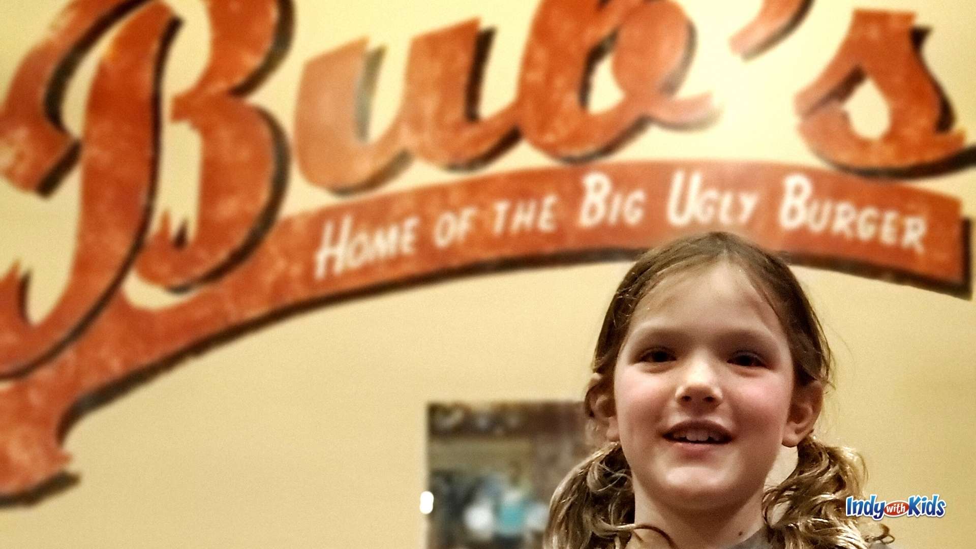 The Best Burger in Indianapolis: A girl with pigtails smiles in front of the Bub's Burgers sign.