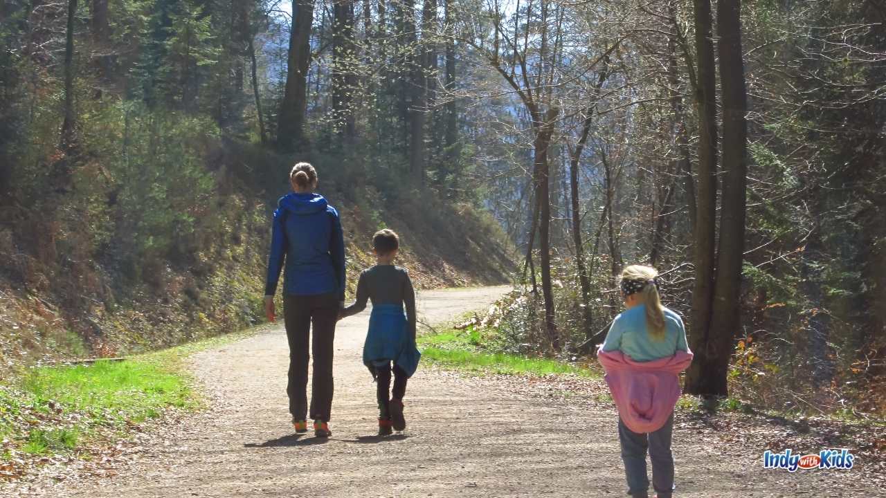 Free Things to Do in Indianapolis: A family hikes down a wooded path.