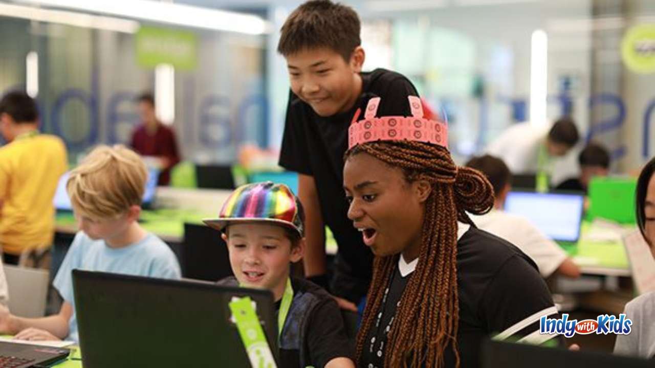 iD Tech a group of students around a computer working together