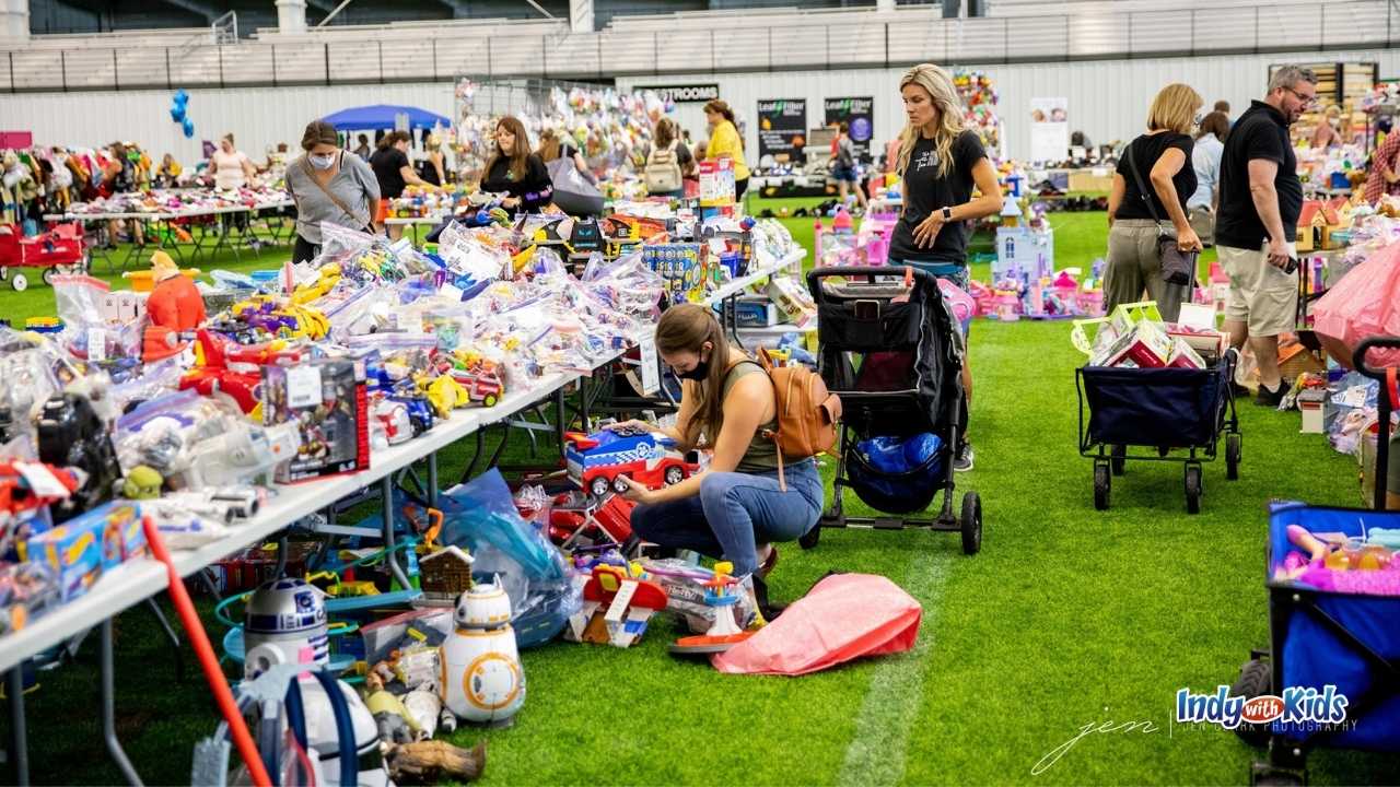 parents comb over toys for sale on tables and on the ground
