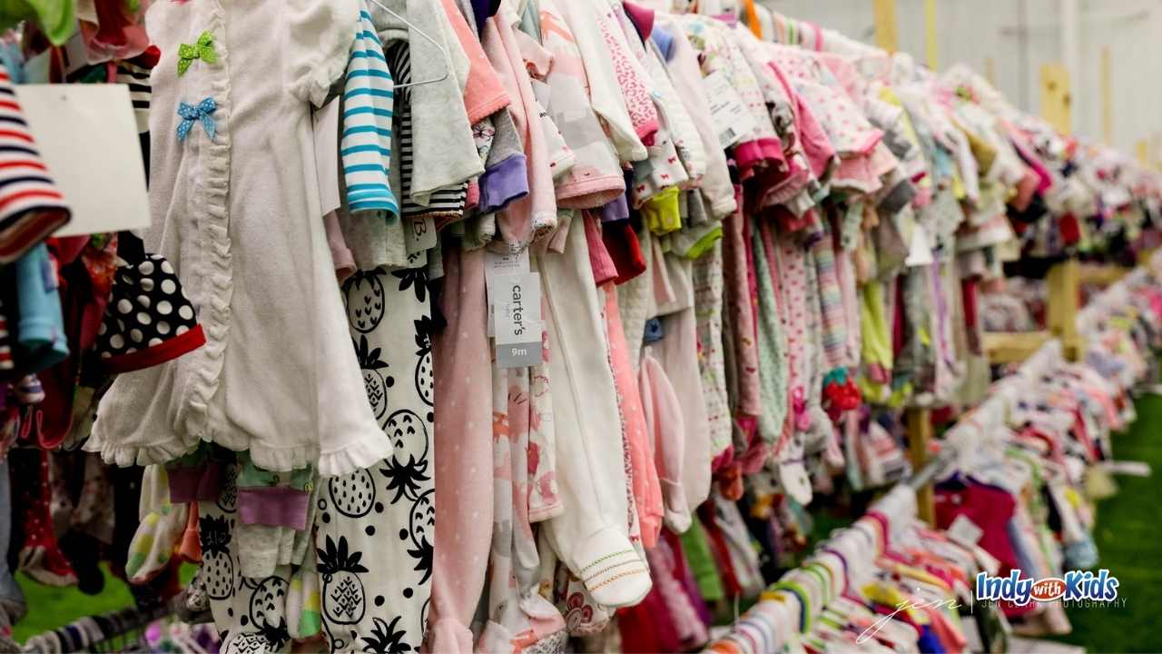 baby clothes, some new with tags, on high and low racks to be sold at whale of a sale