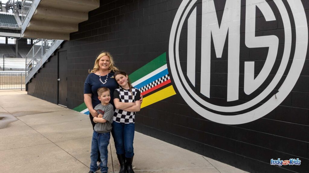 What to Wear to the Indy 500: A mom stands with her two children near the stands at the Indianapolis Motor Speedway.
