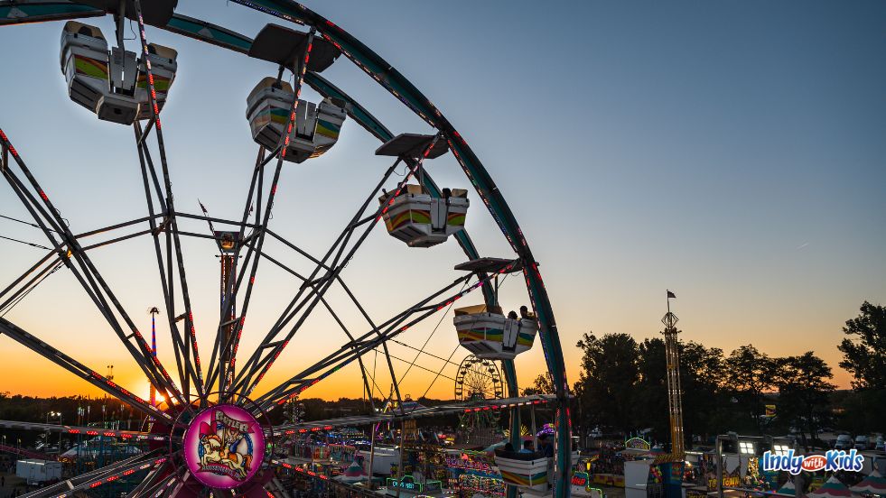 Festivals in Indiana: A Ferris wheel is silhouetted against a summer sunset.