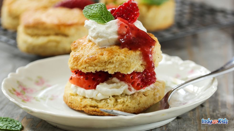 Festivals in Indiana: A strawberry shortcake with whipped cream on a plate, similar to what can be purchased at the Indy Strawberry Festival.