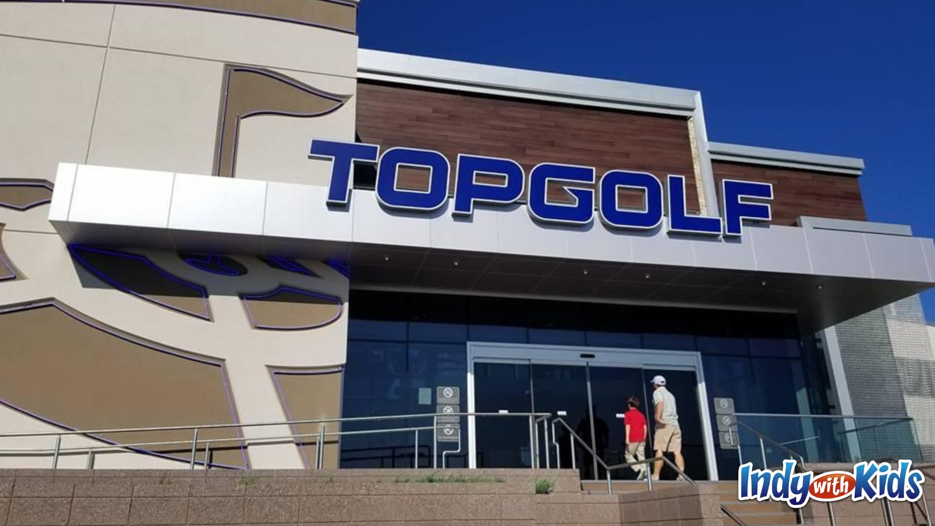 birthday activities for adults: a man and a child enter the front doors of top golf.