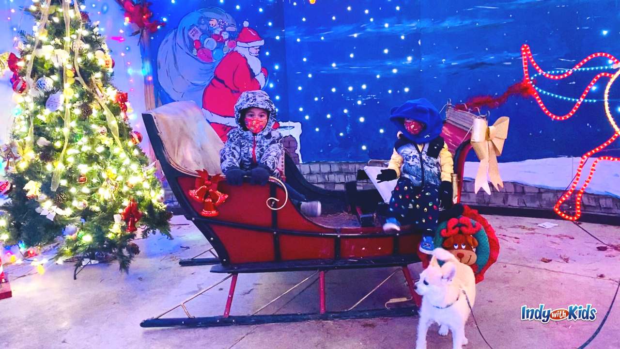 Christmas Pet Photo with children and sleigh. Find places to get pictures with Santa for dogs.