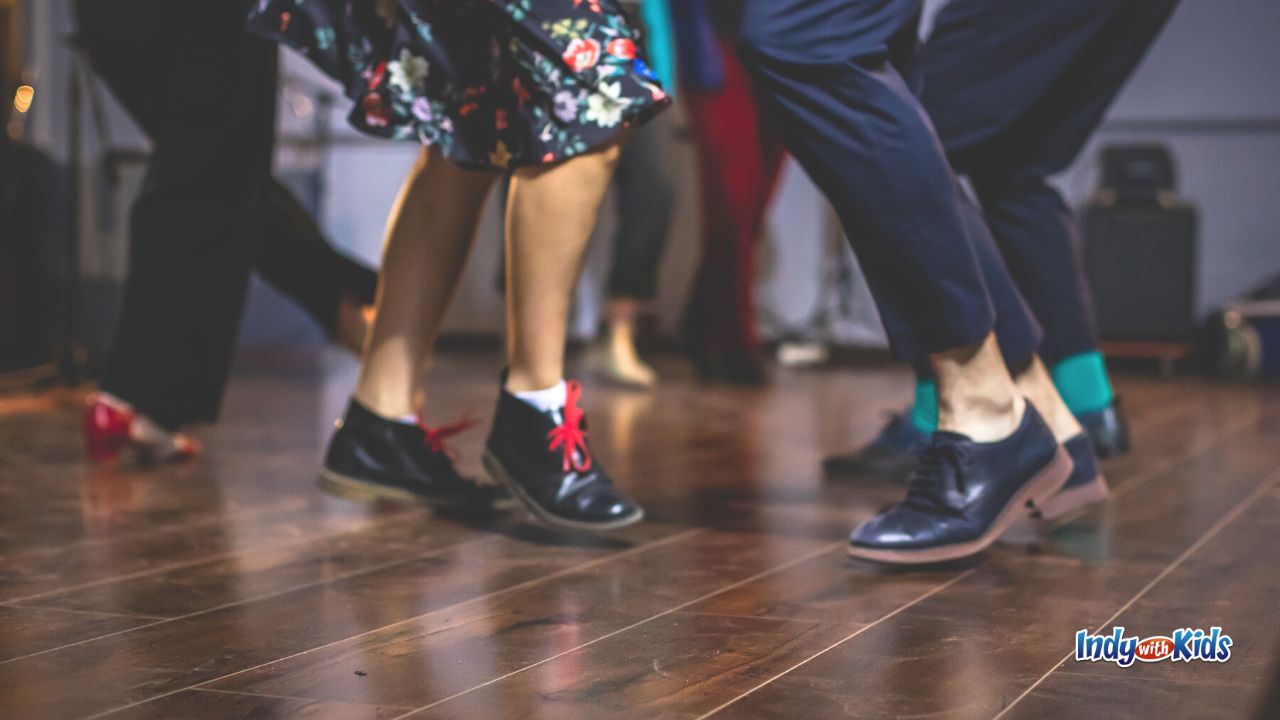 A close up shot of dancing feet wearing vintage shoes on a wood floor. Swing Dancing is one of our top March Date Ideas.