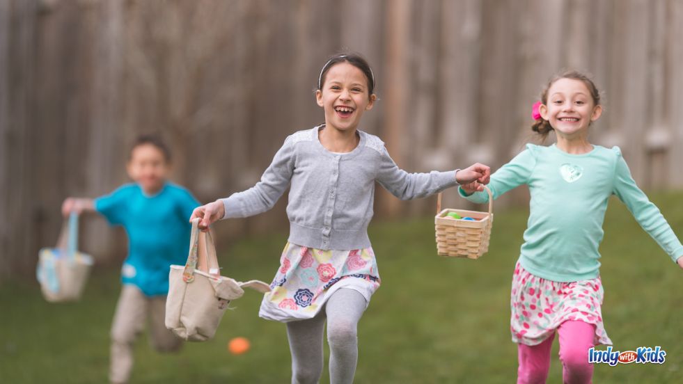 Children race for eggs in a field of green grass at Easter Egg hunts in Indiana.