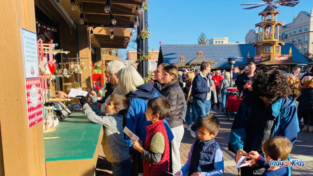 Carmel Christkindlmarkt: children line up to get their passports stamped at a wooden hut