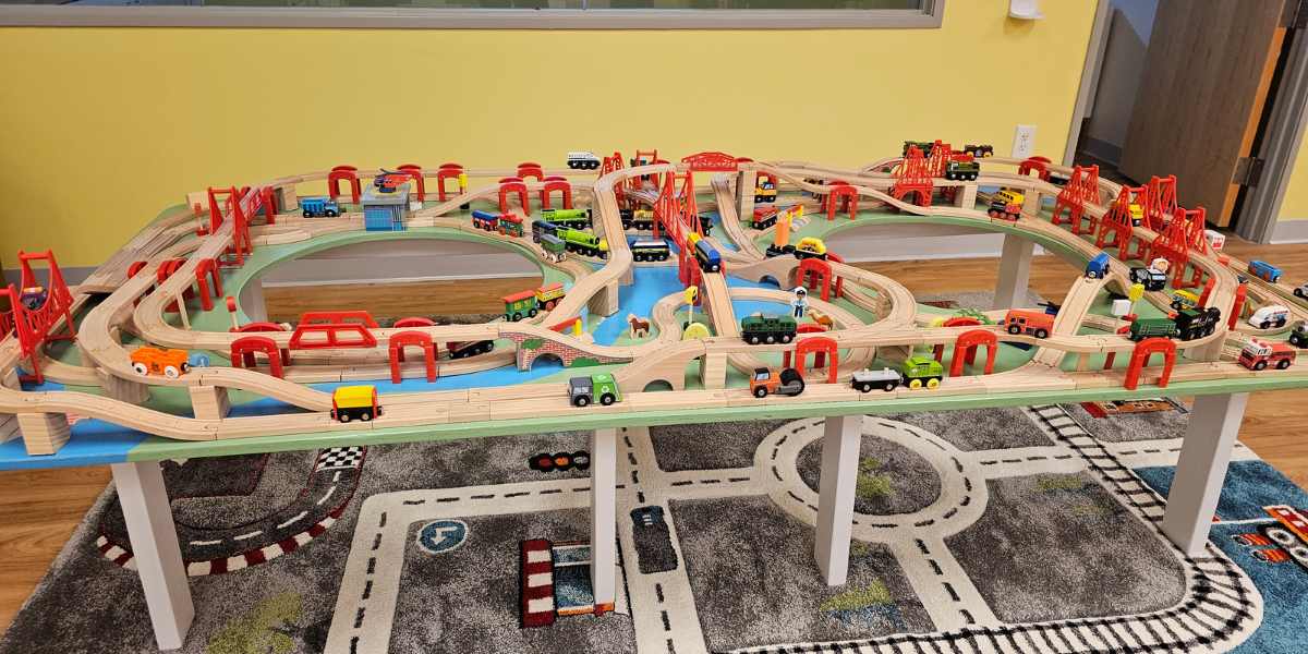 A table is covered with toy trains and tracks at Busy Bee Play Cafe, one of the baby-friendly coffee shops Indianapolis has to offer.