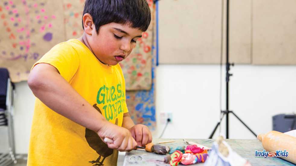 Indy Art Center young boy creates art in the studio