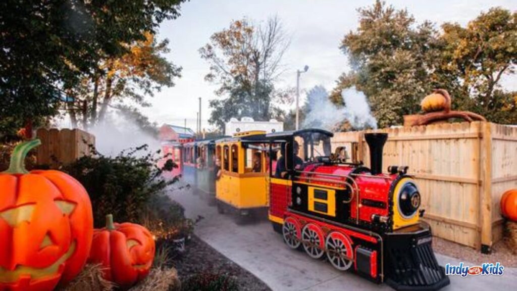 a small steam train rolls through pumpkin town festival at sullivan's hardware