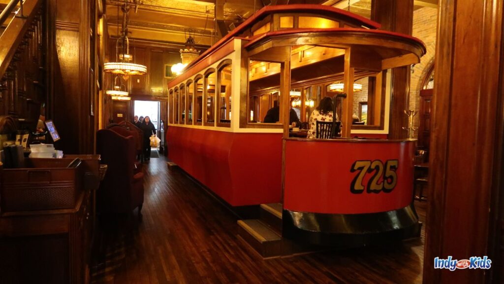 a red trolley dining car sits inside the dining room of the old spaghetti factory restaurant