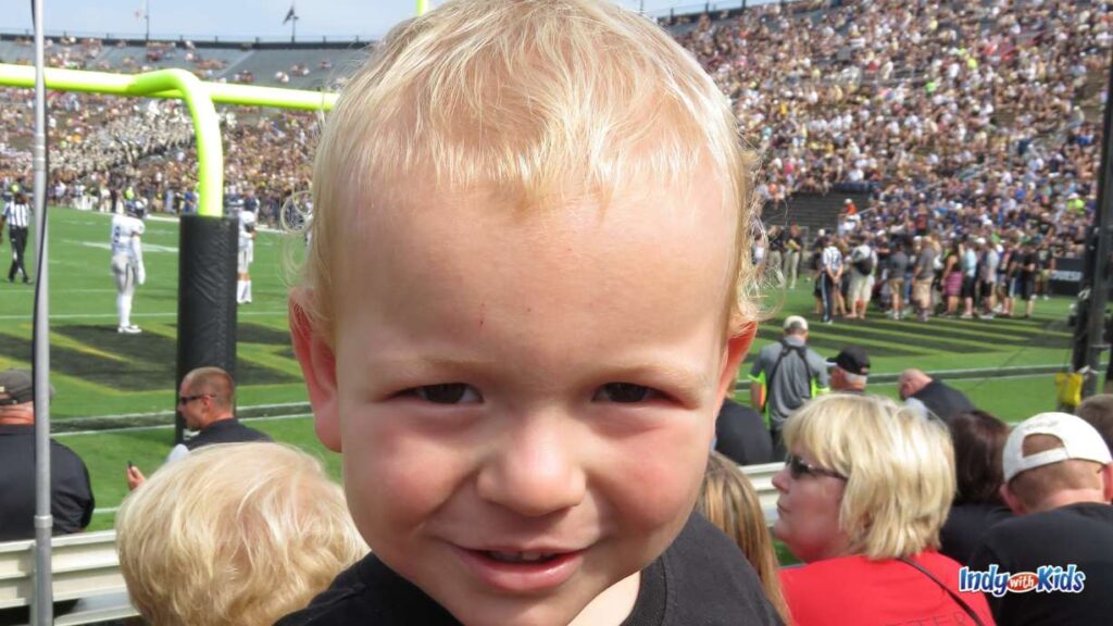 a toddler is in the stands at the purdue boilermakers stadium watching football