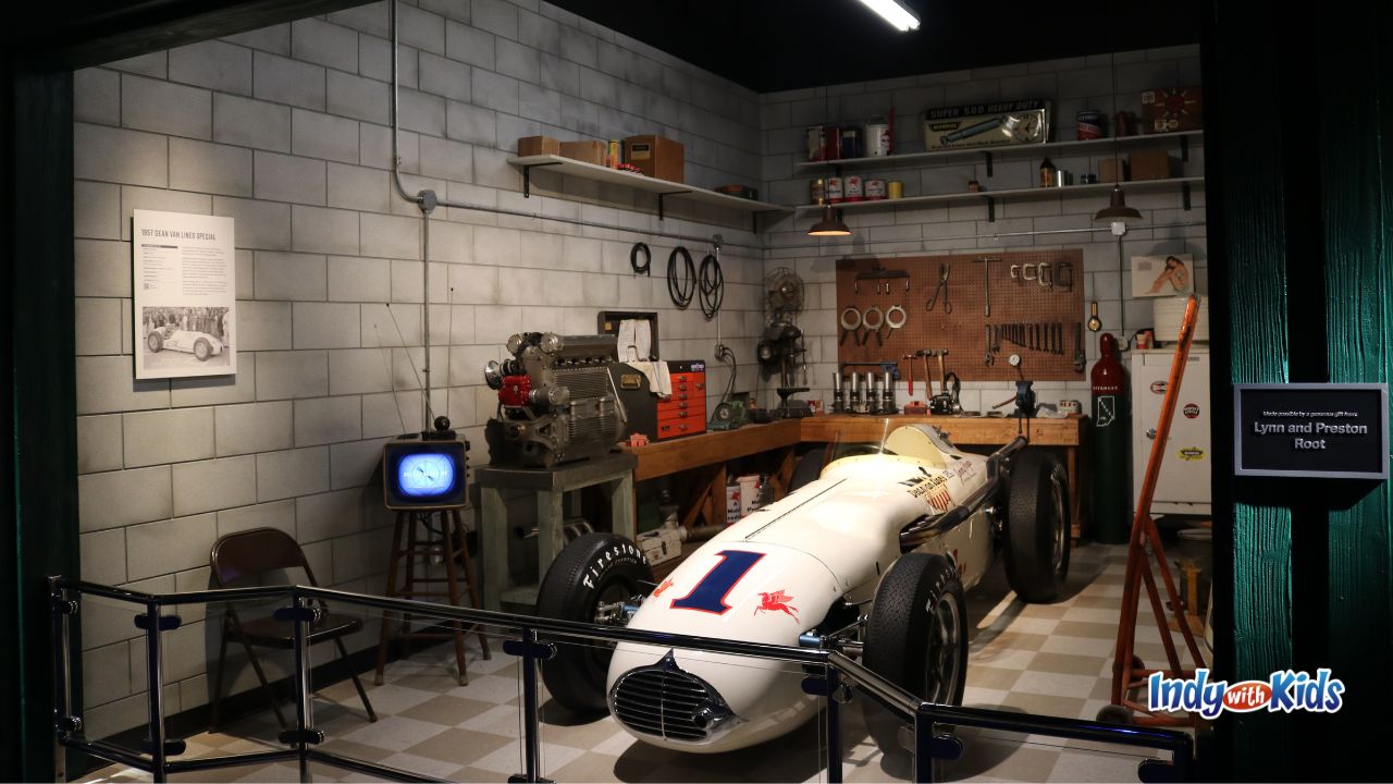 A vintage racing car in a model garage at the Indianapolis Motor Speedway Museum.