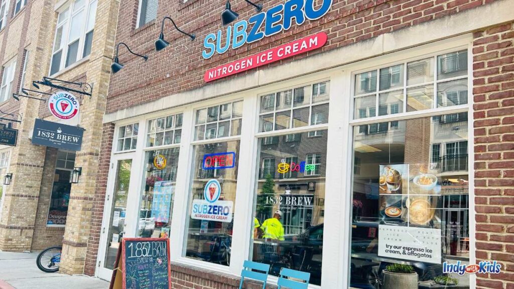 a view of SubZero Nitrogrn Ice Cream from below. There is also a sign for 1832 Brew coffee below their sign. 