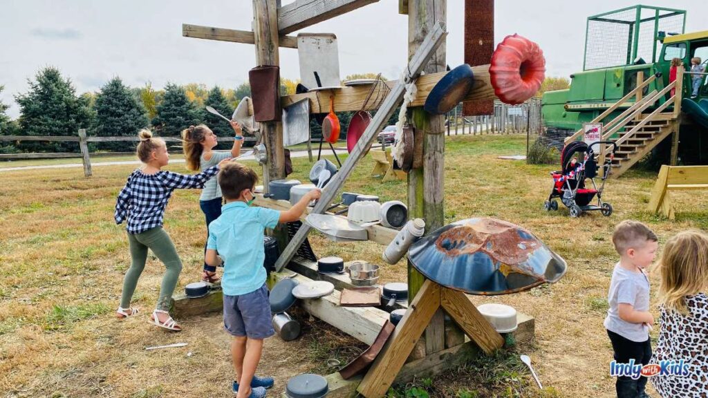 Dull’s Tree Farm and Pumpkin Harvest: several children bang and make music at a music station made with old pots, pans, spatulas, and tin cups.