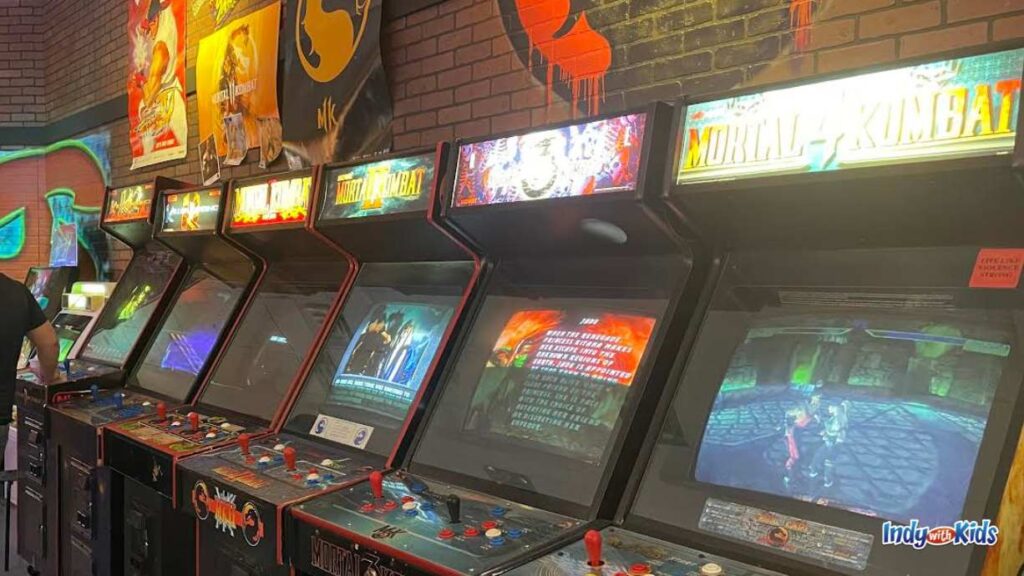 a brick wall is lined with arcade machines like mortal Kombat at Boss Battle Games