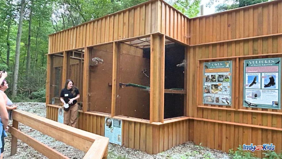 A park employee gives a talk on owls outside the aviary near Eagle Creek Park's Ornithology Center.