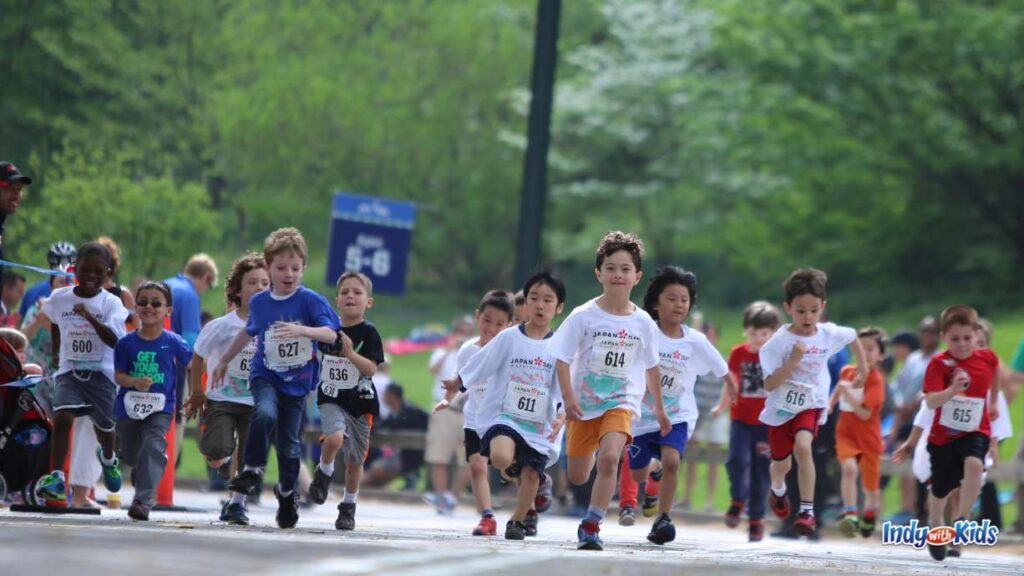 Indianapolis Events OCTOBER EDITION: elementary school aged kids run in a race with numbered bibs