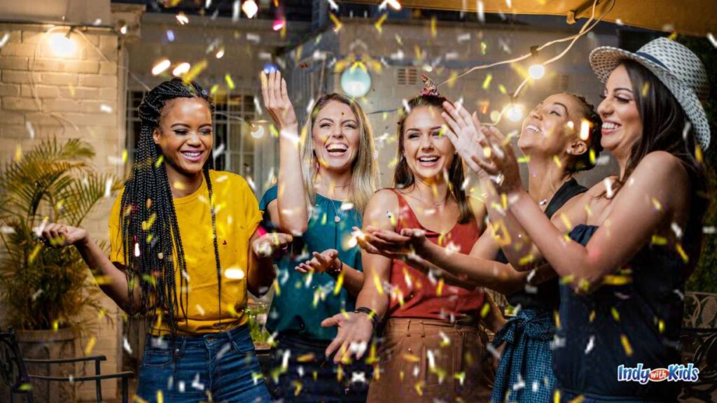 Galentine's Day Events in Indy: 5 women stand under confetti falling at a party