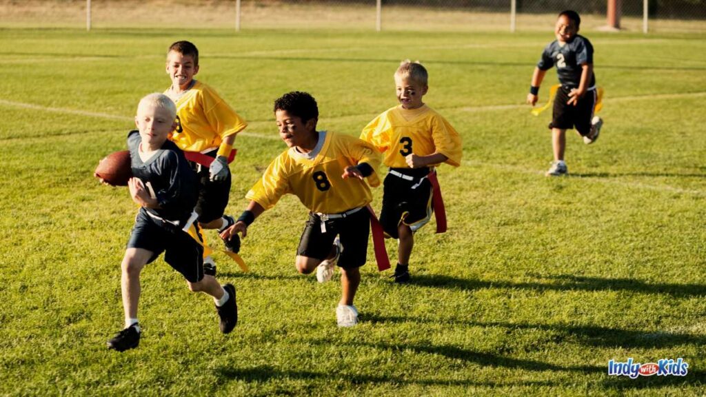 Off the Wall Sports Carmel - boys in yellow and black jerseys play flag football on a grassy field