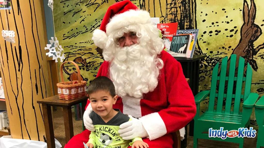 a little boy poses with Santa on the stage at Barnes and noble storytime