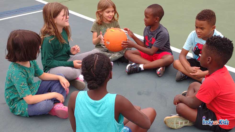 Healthplex Summer Camp kids playing with a basketball