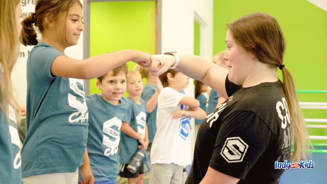 KidStrong Camp girl giving coach a fistbump