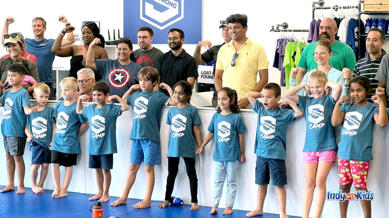 KidStrong Camp parents and kids flexing their muscles