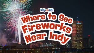 Fireworks burst above the downtown Indianapolis skyline at night during a Fourth of July celebration, with the OneAmerica building illuminated in the background. Text overlay reads “Where to See Fireworks Near Indy.”