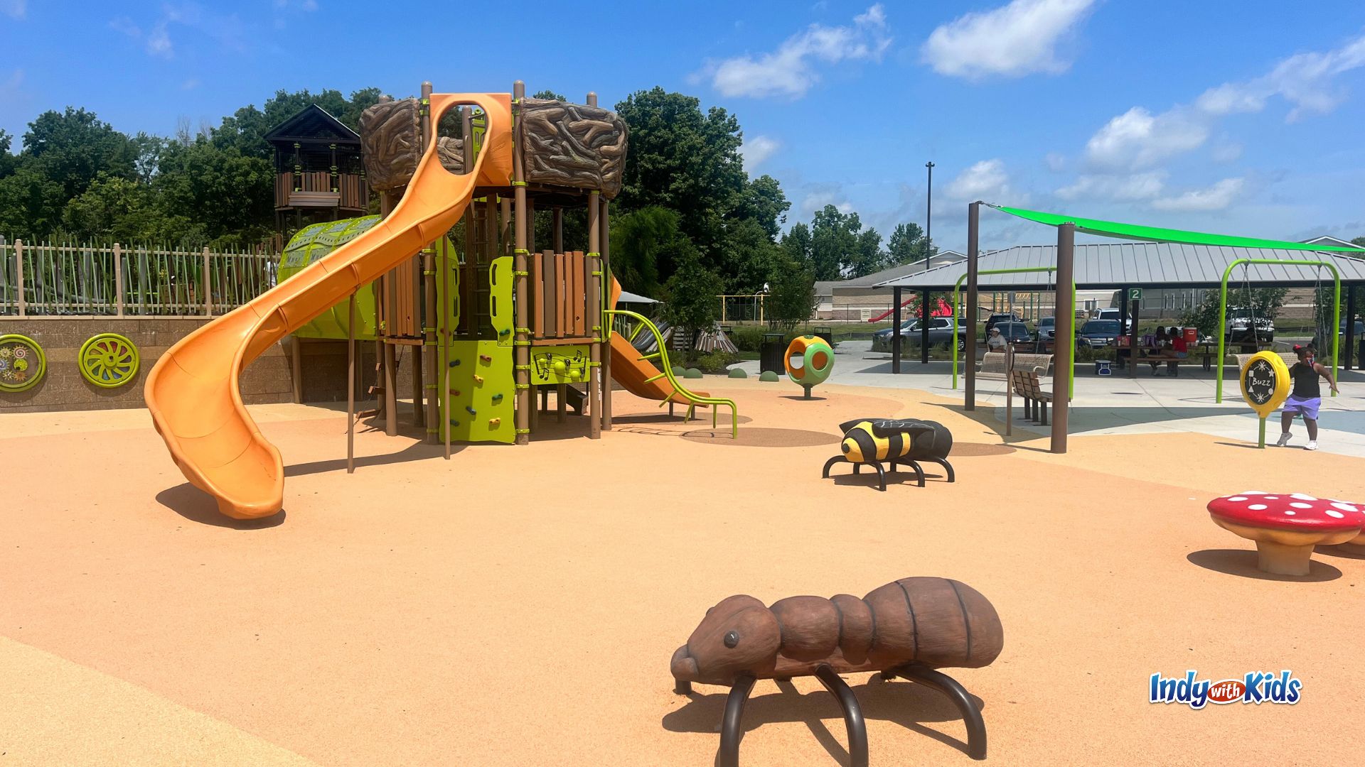 The nature-inspired playground at Grassy Creek Regional Park in Indianapolis has giant insect and mushroom figures to climb on and a birds nest-shaped climbing structure.