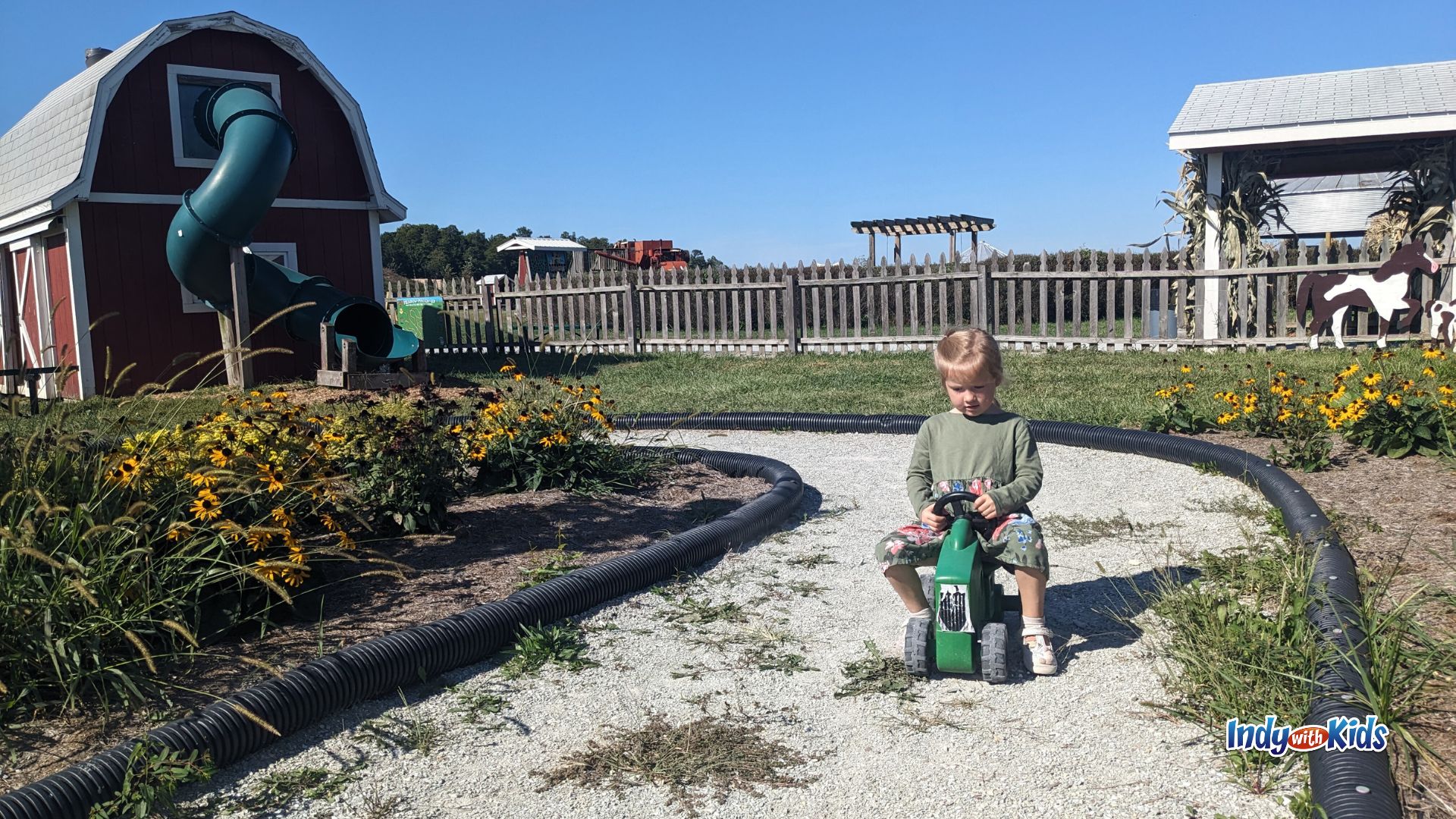 A child rides a tractor scooter in the play area at Tuttle Orchards in Greenfield.