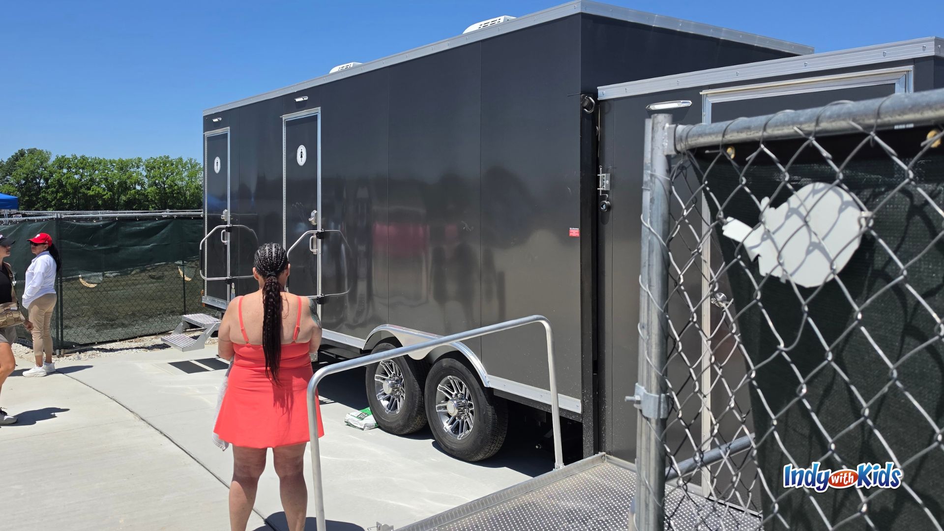 Temporary portable restroom trailers at SKYLAKE Adventure Park with separate entrance doors and a ramp near the beach area.